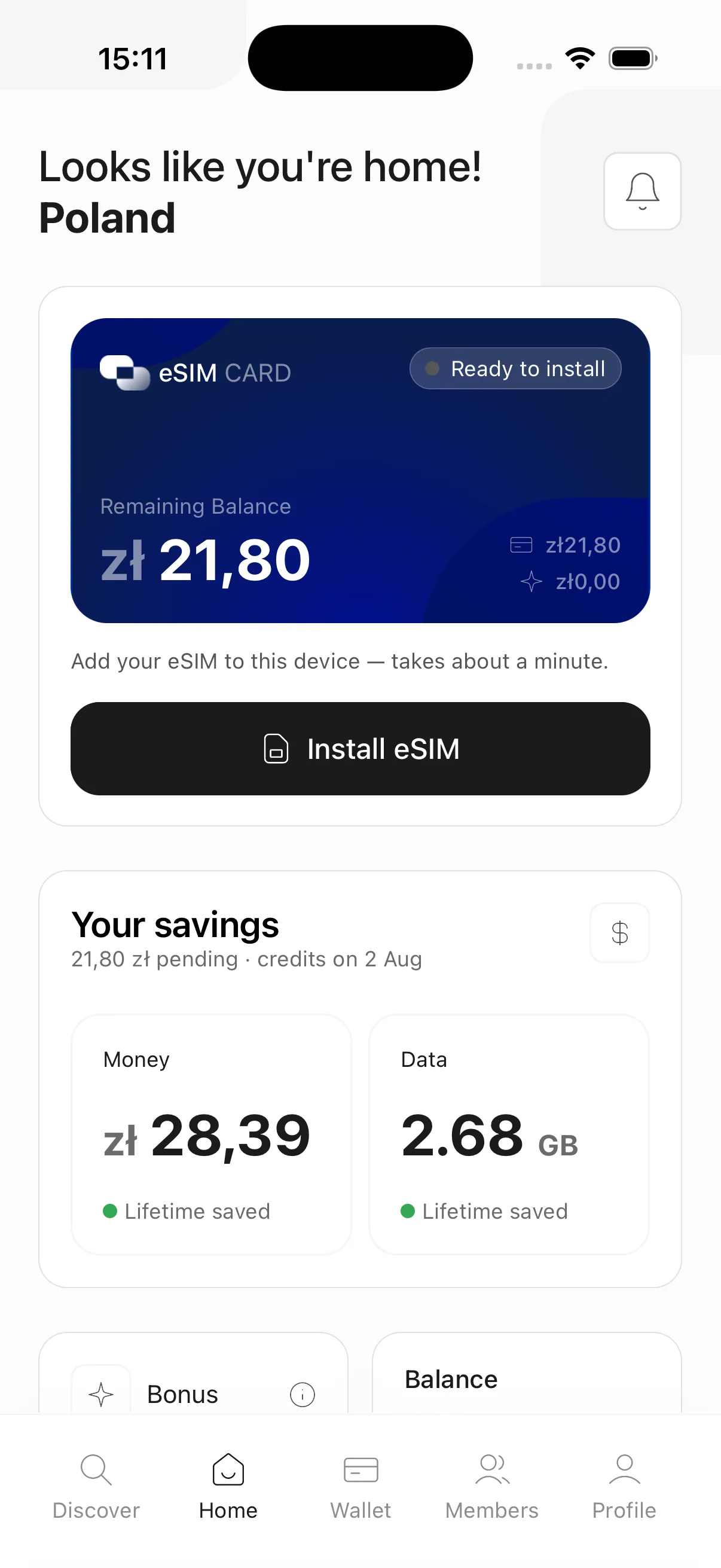The traveler's home screen: a live eSIM card, remaining balance in local currency, and lifetime savings on money and data.